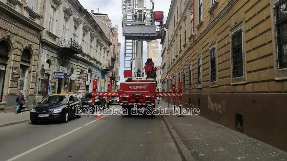 Pompierii, chemați să degajeze tencuiala căzută de pe fațada unei clădiri simbol